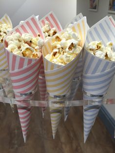 popcorn cones are lined up on a clear shelf