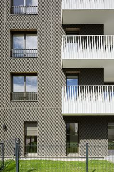 an apartment building with balconies on the second floor