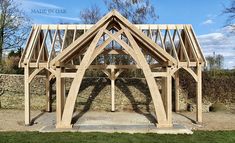 a wooden structure sitting on top of a lush green field