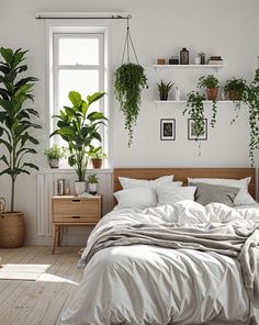 a bedroom with white walls and plants on the wall