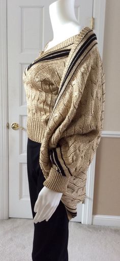 Vintage 1989 Moschino Couture gold lame knit sport wear influenced sweater twin set. The cardigan falls in a cocoon shape. Pull over V-neck is size Italian 40, USA 6, for a tight fit. Cardigan over it is size Italian 42, USA 8 for a looser top layer. Elegant statement piece that adds the whimsy of casual sportswear design. This set from 1989 is unworn from my private art collection. No snags or discoloration. Elegant Gold Sweater For Winter, Elegant Gold Winter Sweater, Gold Knit Sweater For Winter, Gold Knit Winter Sweater, Gold Long Sleeve Sweater, Fitted Gold Cardigan For Fall, Elegant Gold Cardigan For Winter, Elegant Gold Winter Cardigan, Sportswear Design