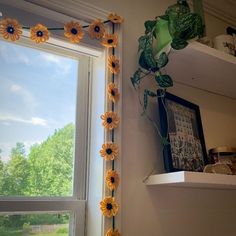 the sunflowers are hanging on the window sill in the room next to the windowsill