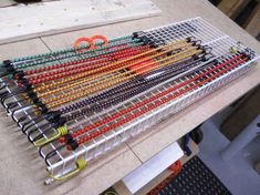 several pairs of scissors sitting on top of a metal rack next to some wires and wire