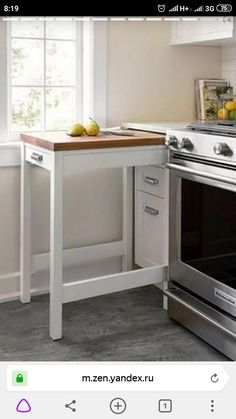 a kitchen with an oven, counter and window