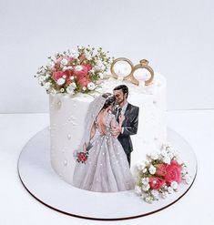 a wedding cake with an image of a bride and groom holding each other's hands