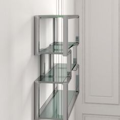 a shelf with glass shelves on the wall