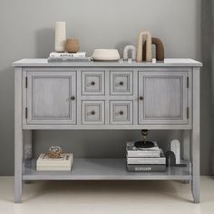 a gray cabinet with drawers and books on top