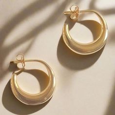 These solid earrings are immensely sleek and of a timelessly attractive form, and are based on examples from ancient Cyprus. Known as "boat" earrings, they feature a gently swollen crescent shape, and a post back. "Tullia" is the female patronymic of the family name Tullius. One famous Tullia was the beloved daughter of Marcus Tullius Cicero (106 - 43 BC), famous orator and statesman of the Late Republic. Cicero had only one daughter, and he was completely devoted to her. When she sadly predecea Elegant Small Hoop Wrap Earrings For Everyday, Elegant Crescent Wedding Earrings, Elegant Crescent Jewelry With Matching Earrings, Timeless Shiny Finish Earrings For Gift, Elegant Crescent-shaped Matching Earrings Jewelry, Elegant Crescent Earrings For Gift, Elegant Crescent Earrings For Formal Occasions, Elegant Crescent Earrings For Formal Events, Elegant Gold Half Moon Hoop Earrings