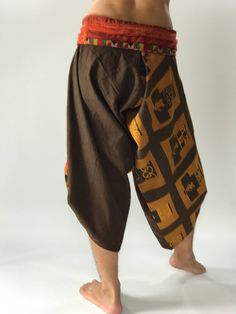 "These special design harem pants have fisherman pants style wrap around waist and belt, totally unlike anything before them. The main fabric is made from pre-washed soft cotton with a subtle texture. The fold-over waist is made from vintage handmade fabric brought from hill tribes in northern Thailand, so they are totally unique. There is one side pocket for your essentials. The hem has matching pull-up tabs for added personality. These performance pants are designed for extreme mobility, perfe Traditional Brown Cotton Bottoms, Traditional Brown Cotton Pants, Traditional Brown Bottoms For Festival, Traditional Brown Harem Bottoms, Yoga Harem Pants, Samurai Pants, Handmade Pants, Genie Pants, Fisherman Pants