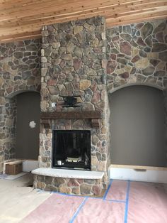 a stone fireplace in the middle of a room