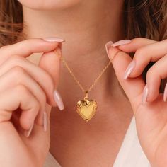 Our dainty gold heart locket with a secure closure is a classic piece that fits every occasion. This locket necklace is made with high-quality materials and expertly crafted to showcase your most cherished memories. ∙DETAILS Chain: 16'' + 2'' Pendant: 20mm x 18mm Made of 925 Sterling Silver Plated with 18K gold Waterproof & hypoallergenic ∙ ∙SHIPPING IMPORTANT: before placing an order, please double check that your address is correct to avoid any delays. Shop more one-of-a-kind pieces: https://w Gold Heart Pendant Locket Necklace, Gold Locket Necklace For Mother's Day Anniversary, Gold Locket Necklace With Heart Charm As Gift, Gold Heart Pendant Locket Necklace For Anniversary, Gold Locket Necklace For Valentine's Anniversary, Gold Heart Locket Necklace For Anniversary Gift, Dainty Heart Locket Necklace For Anniversary, Heart Cut Locket Necklace For Anniversary, Gold Locket Necklace For Anniversary And Mother's Day