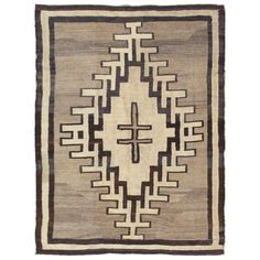 an old rug with black and white designs on the bottom, in front of a white background