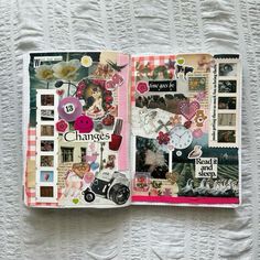 an open scrapbook with various pictures and words on it, sitting on a white surface