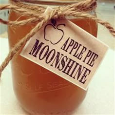 a mason jar filled with apple pie moonsshine