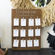 a bulletin board with notes pinned to it and hanging on clothes pins in front of a mirror