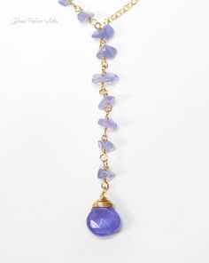 "This necklace is made with real bright Tanzanite. Tanzanite gemstone chips create a beautiful texture on this unique necklace. Available in Gold or Silver - Attached are genuine tanzanite gemstones (teardrop stone measures about 11 - 12 mm) - 14k gold fill or sterling silver chain and spring clasp - Necklace is shown at 18\" length - The length measurement does not include the dangle section - The Tanzanite dangle is approx 2 inches additional length - The tiny gemstones are unique and will var Natural Stones Lariat Dangle Necklace For Gifts, Natural Stones Dangle Lariat Necklace Gift, Dangle Lariat Necklace With Natural Stones As Gift, Dangle Lariat Necklace With Natural Stones For Gifts, Gift Natural Stones Dangle Lariat Necklace, Gemstone Dangle Lariat Necklace As Gift, Gemstone Beads Dangle Drop Necklace, Dangle Drop Necklace With Natural Stones For Gift, Drop Necklace With Natural Stones For Jewelry Making