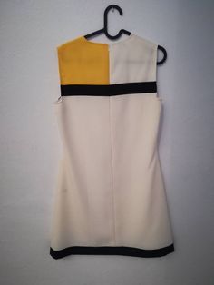 "AIDA DRESS Handmade dress 100% Polyester Colors: white, yellow, black Mondrian dress This dress is made under request, so there is no stock. Since is only made under request, can not be returned ( read my policies concerning conditions for exchanges or returns) CAN I CHANGE THE COLOR? YES Just add to your cart the listing special request, aswell for lining or other changes as alterations https://www.etsy.com/uk/listing/624364219/special-requests?ref=shop_home_active_1&frs=1 ARE YOU ON A RUS Retro Yellow Mini Length Dress, Modern White A-line Mini Dress, Yellow Retro Mini Dress, Retro Yellow Mini Dress, Yellow A-line Retro Dress, White A-line Mini Dress In Mod Style, White A-line Mod Dress, Yellow A-line Mini Dress For Work, Mod Mini Dress For Work