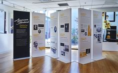 an exhibit room with three white and black displays