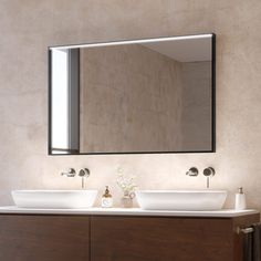 a bathroom with two sinks and a large mirror