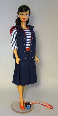 a doll is dressed in a sailor outfit