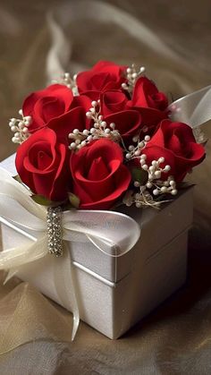 a white box with some red roses in it