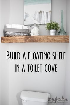 a white toilet sitting next to a wooden shelf