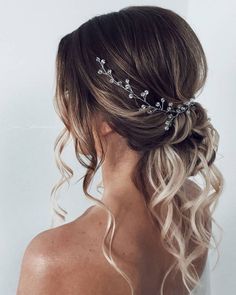 a woman with blonde hair wearing a wedding hairstyle