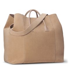 Practical and stylish, this oversize weekender bag is ideal for a getaway. Expertly made to the highest standards in Florence, Italy, it has shoulder straps or a longer detachable strap can be used for ease of transport. Suede Nappa leather Inside pocket Dimensions: 17.7"l x 9.8"w x 14.6"h Comes in a protective dust bag Made in Italy Care instructions: Only clean with a dry brush or dry cloth | AERIN Suede Oversized Weekender size 17.7"l x 9.8"w x 14.6"h | AERIN Suede Oversized Weekender Bag in Dry Brush, Croc Leather, Candle Accessories, Florence Italy, Office Accessories, Bag Bag, Nappa Leather, Leather Mini, Weekender Bag