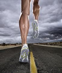 a man running down the middle of an empty road with storm clouds in the background