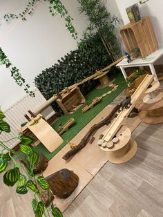 a room filled with lots of different types of wooden furniture and plants on the floor