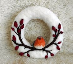 a felt wreath with a bird on it