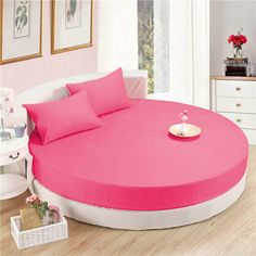 a round bed sitting on top of a hard wood floor