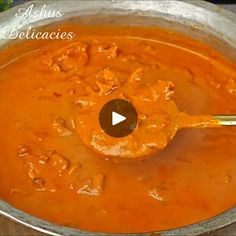 a ladle full of red sauce being stirred by a wooden spoon in a pot