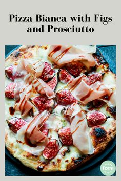 pizza with figs and prosciutto on it sitting on a blue surface