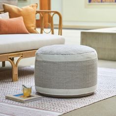 a white ottoman sitting on top of a rug