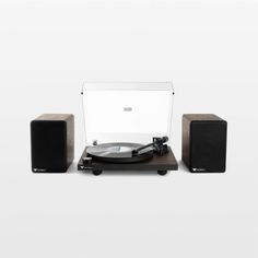 a record player and speakers on a white background