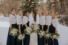 a group of women standing next to each other in the snow