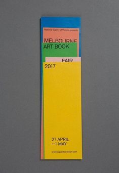 a yellow and blue bookmark with the words melbourne art book fair on it's side