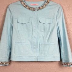 This Is A Cute Cropped Light Blue Jacket. The Jacket Has Beading And Stones Lining The Neck And Sleeves. The Jacket Is In Excellent Condition With Tags. There May Be 2 Loose Beads, But They Are Not Noticable. The Jacket Has Snap Closures Down The Front And On The Sleeves. Fabric Is Linen, Rayon, And Spandex. Blue Embellished Fitted Outerwear, Fitted Blue Embellished Outerwear, Spring Blue Beaded Outerwear, Spring Embellished Outerwear For Work, Spring Embellished Workwear Outerwear, Fall Blue Beaded Outerwear, Elegant Embellished Blue Outerwear, Elegant Blue Embellished Outerwear, White Jean Vest