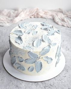 a frosted cake sitting on top of a white plate