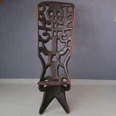 a wooden chair sitting on top of a white table