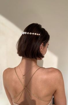 The Allison Pearl Halo is a timeless headpiece that will elevate your look. With gradual sized pearls on a 14 karat gold plated headband, this halo can be worn on the back of your head as a halo or at the nape of your head as a crown. Made in NYC Adjustable Classic Pearl Necklace For Wedding, Elegant Adjustable Pearl Necklace For Evening, Halo Hair Accessories, Formal Bridal Accessories With Pearl, Formal Bridal Pearl Accessories, Formal Pearl Bridal Accessories, Elegant Pearl Bridal Accessories For Formal Occasions, Elegant Headpiece With Pinched Crown For Gift, Timeless Akoya Pearl Necklace For Wedding