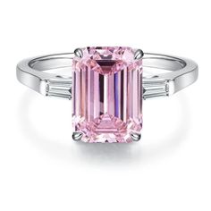 a pink diamond ring with three baguets on the side