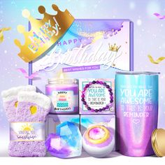 a birthday gift box with candles, cookies and other items in front of a purple background