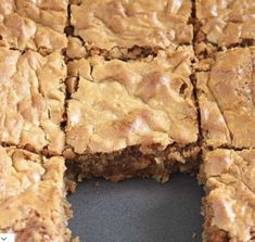 some brownies are cut into squares and placed on top of each other with one bite taken out