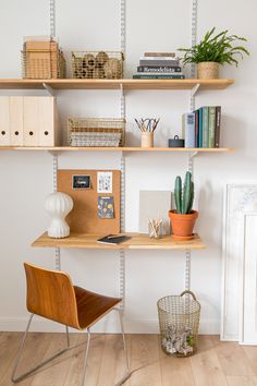 the shelves are filled with books, plants and other things to do in this home office