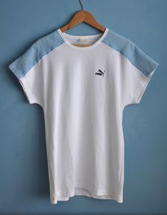 Vintage white and baby blue PUMA sports top, from the 1980s Summer 80s PUMA top with dolman short sleeves and long straight shape. The top features light blue terry cloth pieces on the shoulders, the rest is white! Has the brand's logo on the front Material - cotton and polyester, fabric is thick, not lightweight! Size - L Measurements (taken while top is lying flat, double armpit to armpit): Shoulders (undefined), measured from one sleeve's end to the other - 28.5 inches / 72.4 cm Armpit to Arm 90s Style White Short Sleeve T-shirt, 90s Sports T-shirt For Summer, White Short Sleeve T-shirt With 90s Style, White Short Sleeve T-shirt 90s Style, White Sporty Top For Summer, Sporty White Top For Summer, Retro Sports T-shirt For Summer, White Retro Sports T-shirt, Retro White Sports T-shirt