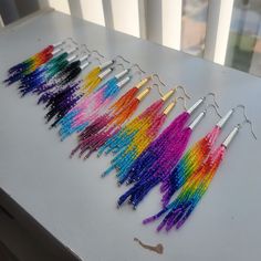 several pairs of beaded earrings are lined up on a table