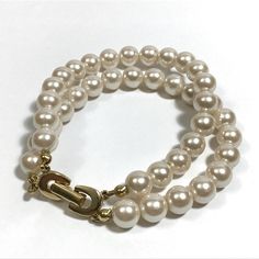 DESCRIPTION: Vintage ivory/cream double strand simulated pearl bracelet with gold tone fold over clasp closure, unknown maker, circa late 1980s-1991. MEASUREMENTS: The faux pearl bracelet measures 7 1/4 inches in length when opened and lying flat and approximately 3 inches in diameter with the clasp closed. The pearl beads are 1/4 inches wide. CONDITION: The bracelet is in very good vintage condition. Please see photos for condition details. There's more to see in our Jewelry shop section! Elegant Beige Bracelet For Formal Occasions, Elegant Beige Bracelets For Formal Occasions, Elegant Adjustable Cream Pearl Bracelet, Elegant Beige Bracelets, Elegant Adjustable Cream Bracelet, Elegant Cream Pearl Bracelet With Round Beads, Elegant Cream Bracelet For Formal Occasions, Elegant Cream Pearl Bracelet For Formal Occasions, Elegant Cream Bracelet For Formal