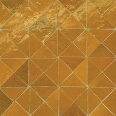 an orange and brown tiled floor with small squares on it's sides, in the middle